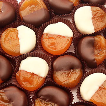 Photo of dried apricots dipped by hand in either white or dark chocolate - this mix contains both.
