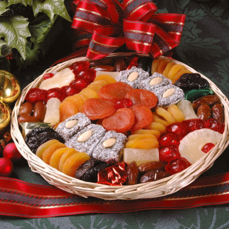 A photo of a round basket product. This one contains dried and candied fruits, as well as date and coconut nut roll treats.