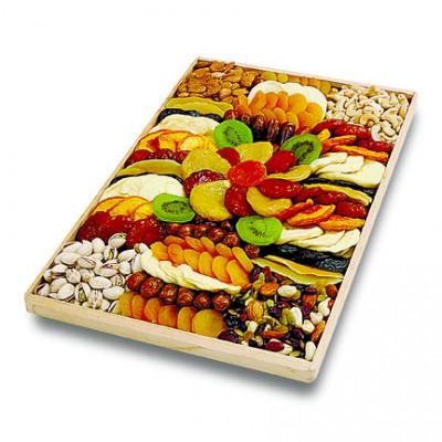 Photo of the wood tray. This rectangular wooden tray is fulled with a variety of dried fruits and nuts arranged in a colorful pattern.